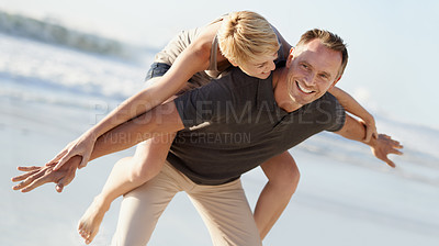 Buy stock photo Couple, love and smile on beach with piggyback for bonding, honeymoon date and weekend holiday. Face, man and woman with embrace, happy and care in California by sea for vacation, travel or adventure