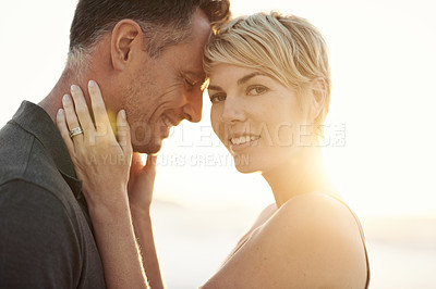 Buy stock photo Couple, beach and sunset embrace on holiday for marriage commitment for vacation, summer or travel. Man, woman and connection in evening at California paradise for relax date, happiness or outdoor