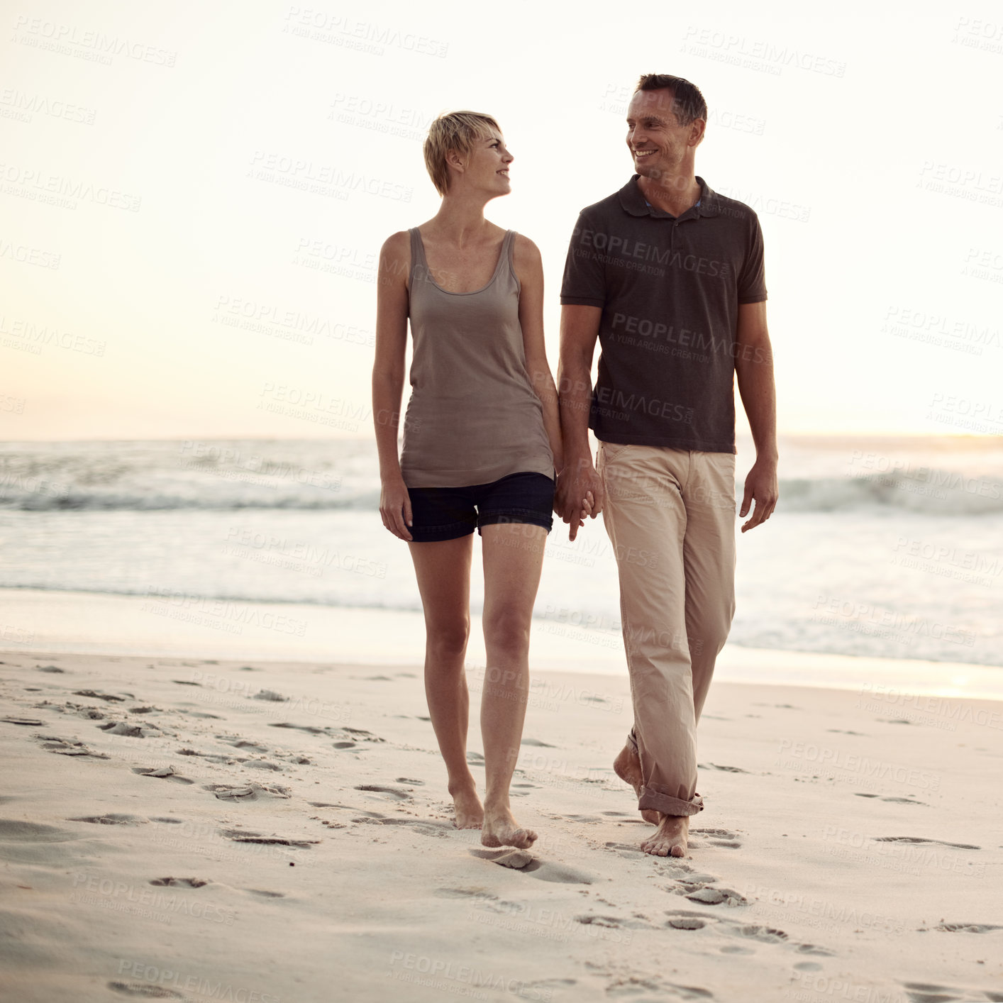 Buy stock photo Shot of a mature couple taking a walk on the beach