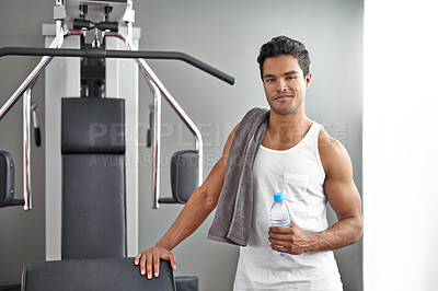 Buy stock photo Gym, machine and portrait of man with water bottle for recovery after exercise for body building. Healthy, fitness and person relax after workout with hydration for benefits to muscle and wellness