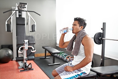 Buy stock photo Fitness, gym and man drinking water for training, wellness or exercise recovery, break or resting. Workout, hydration and thirsty male athlete with sports drink after intense, cardio or bodybuilding