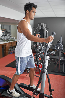 Buy stock photo Fitness, health and man with air walker in gym for commitment to cardio improvement workout routine. Exercise, running or walking with confident young athlete on equipment for full body training