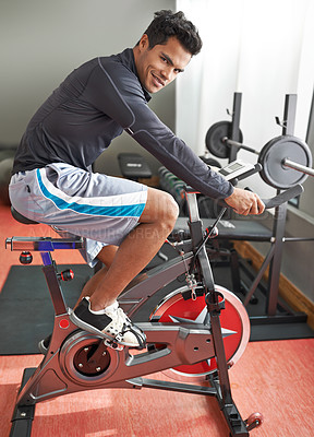 Buy stock photo Fitness, bicycle and portrait of man in gym for cycling marathon, race or competition training. Fitness, health and athlete riding spinning machine for cardio workout or exercise in sports center.