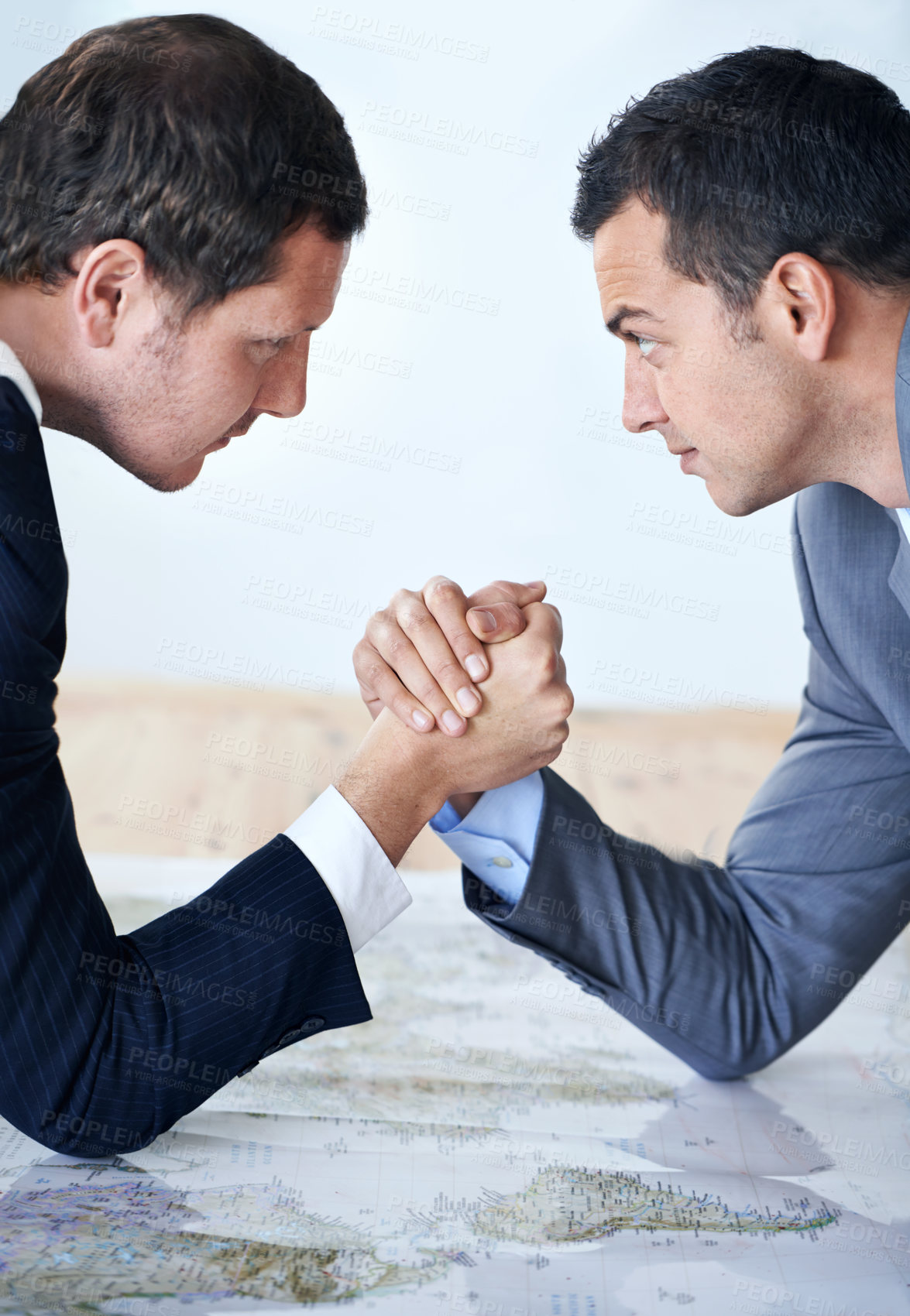 Buy stock photo Businessman, handshake and arm wrestle for competition, challenge or strength on table at the office. Serious man, corporate employees or business partners shaking hands for game, contest or battle