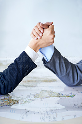 Buy stock photo Map, arm wrestle and power struggle with business people in studio for battle, competition or war. Hands, strategy or challenge with corporate employee and rival fighting for global domination