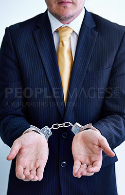 Buy stock photo Hands, person in business and handcuffs for crime or bribery, suspicious professional deal with justice or jail. Fraud, corruption or money laundering, shackles for prison with thief or criminal