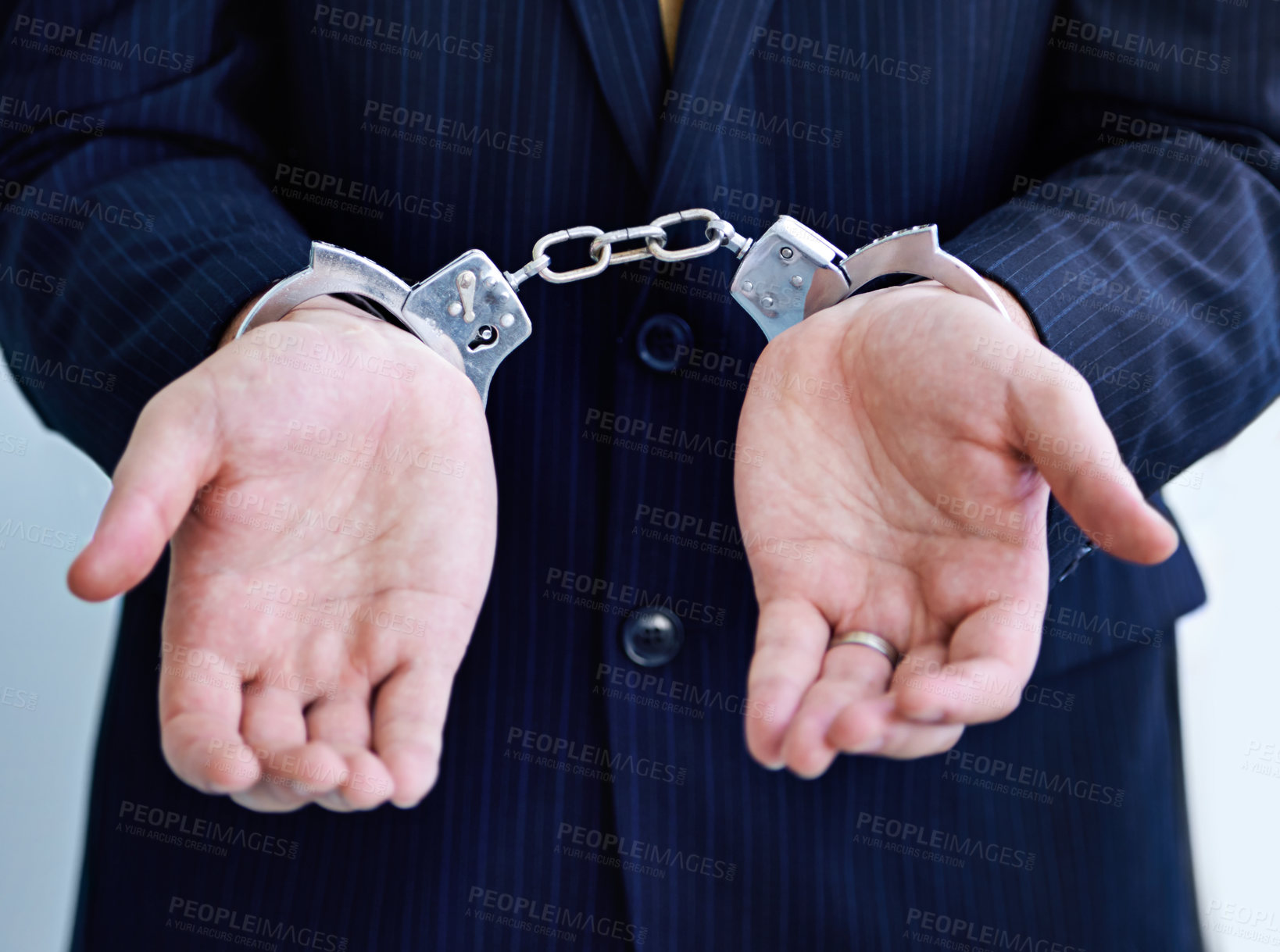 Buy stock photo Hands, person in business and handcuffs for fraud or bribery, suspicious professional deal with justice or jail. Crime, corruption or money laundry, shackles for prison with thief or criminal