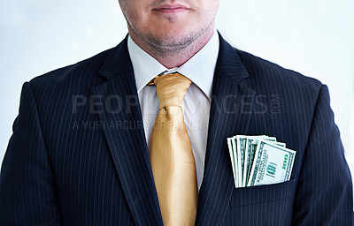 Buy stock photo Suit, serious and businessman with money in pocket for bribe, fraud or financial scam in studio. Corruption, pay and closeup of professional male person with cash for crime by white background.