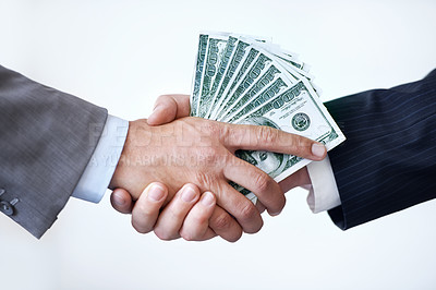 Buy stock photo Studio shot of two men shaking hands after making a monetary deal