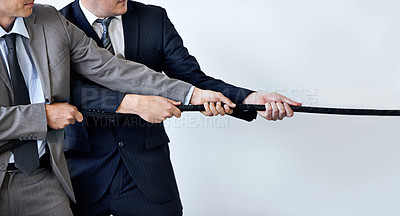 Buy stock photo Hands, partnership and tug of war with businessmen in studio for collaboration, competition or effort. Teamwork, rope and challenge with corporate people pulling together for strength or struggle
