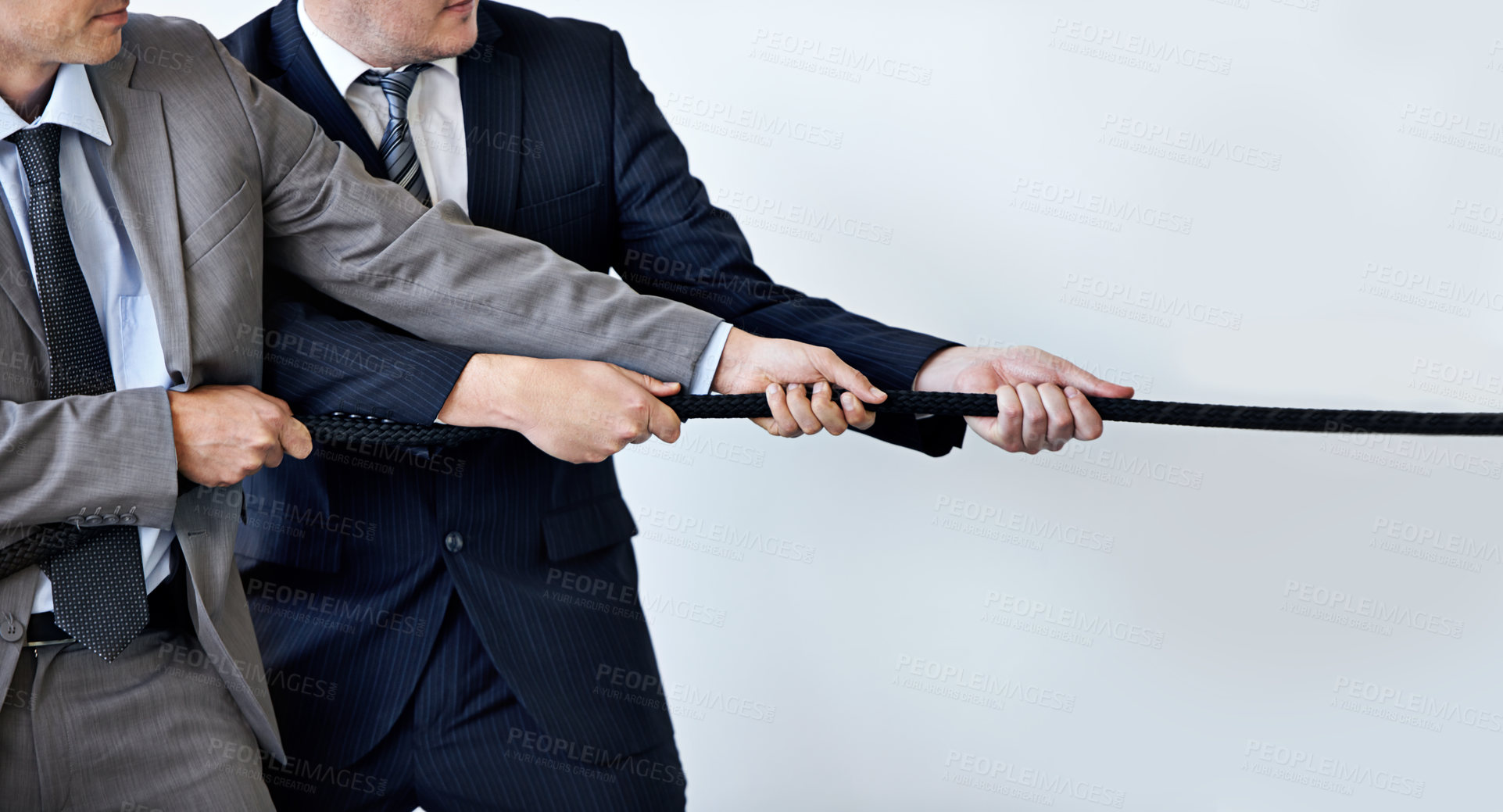 Buy stock photo Hands, partnership and tug of war with businessmen in studio for collaboration, competition or effort. Teamwork, rope and challenge with corporate people pulling together for strength or struggle