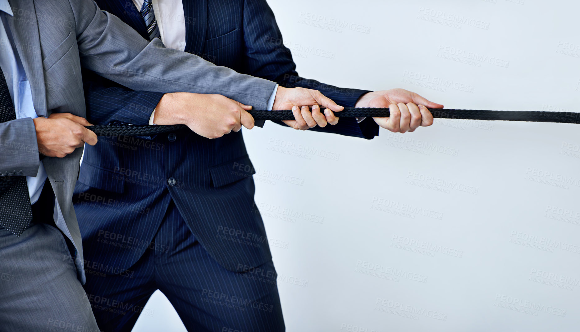Buy stock photo Studio shot of two businessmen pulling on a rope