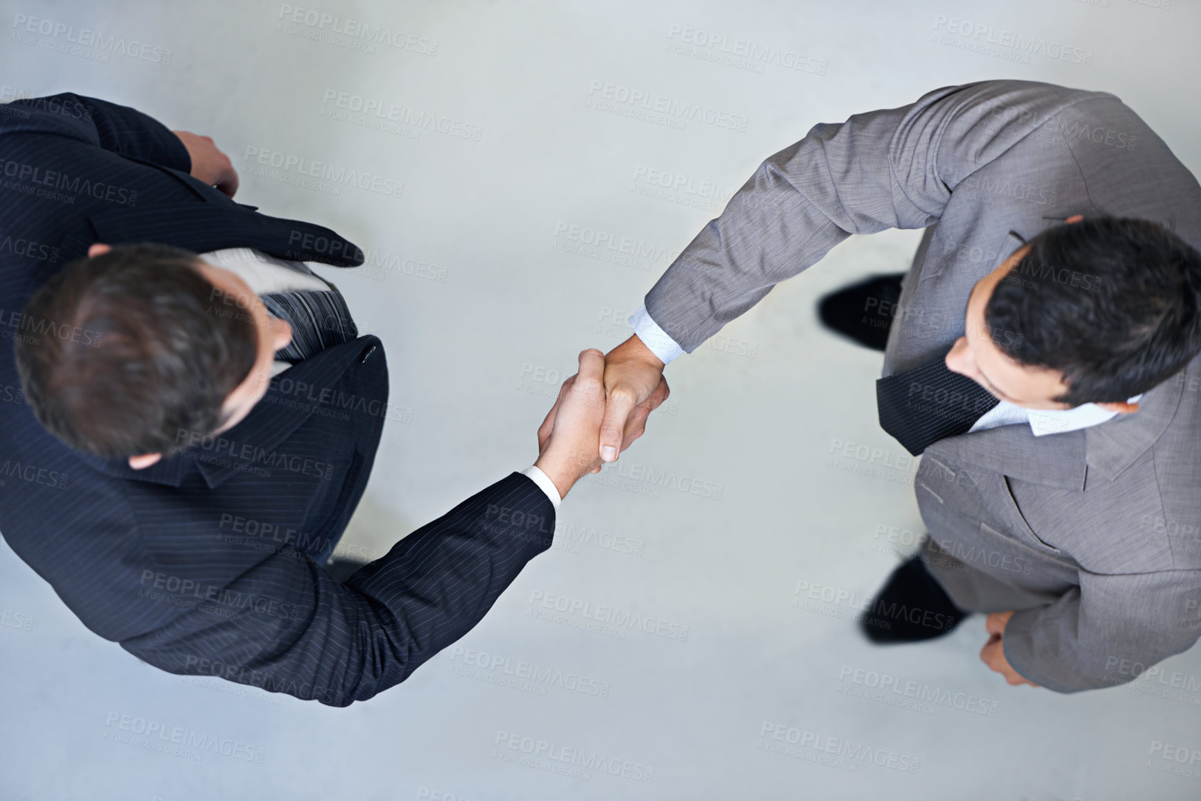 Buy stock photo High angle view of two businessmen shaking hands