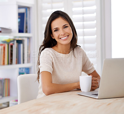 Buy stock photo Portrait of an attractive young woman using her laptop at home