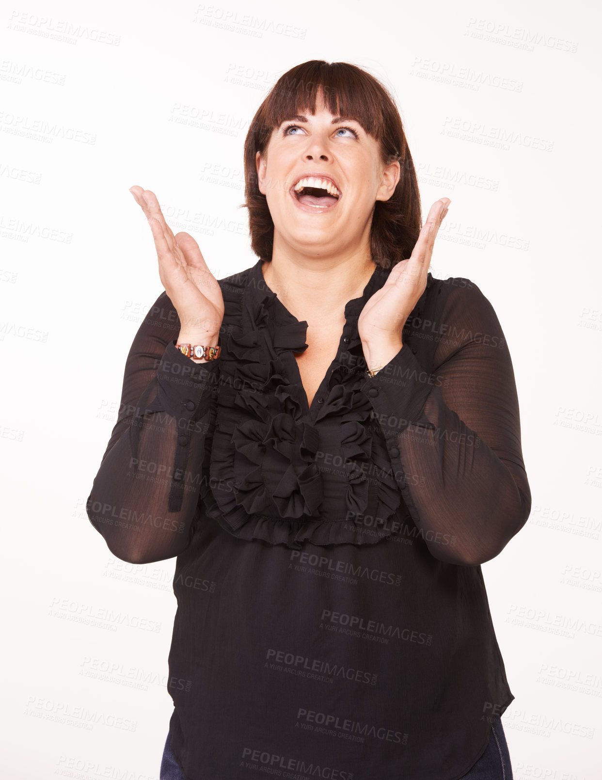 Buy stock photo A happy young woman with her hands in the air while looking up - white background