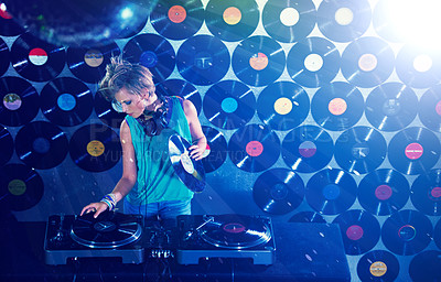 Buy stock photo Woman dj, headphones and vinyl records in night club for party with turntable, lights and lens flare. Gen z female person, retro or mixing decks at event with energy, techno and music in Berlin disco