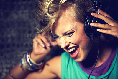 Buy stock photo A young female dj listening to some mixes on her headphones