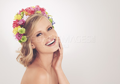 Buy stock photo A young woman with a flower arrangement in her hair smiling at the camera
