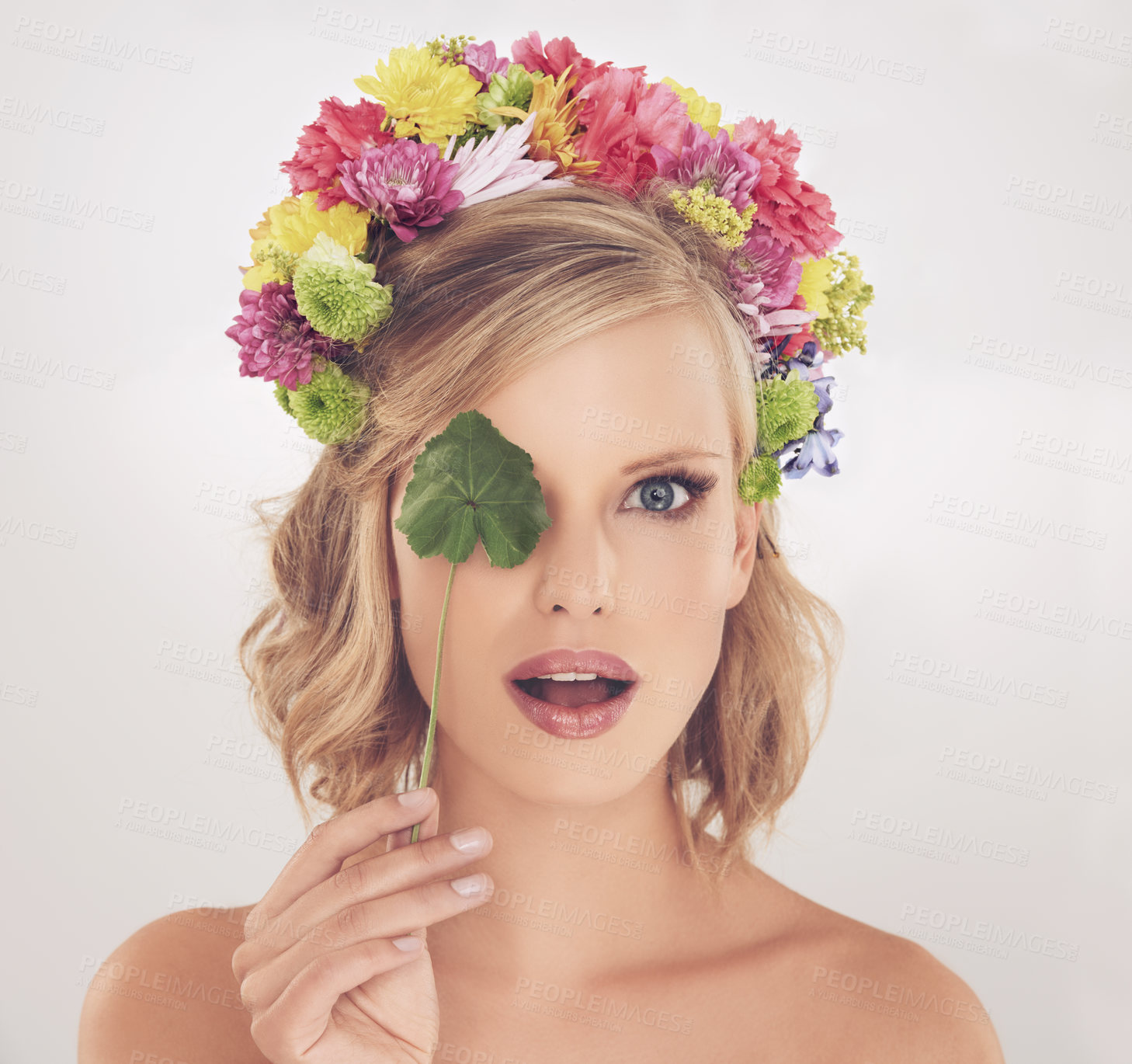 Buy stock photo Woman, portrait and surprised with flowers on crown in studio with makeup and leaf for cosmetics and skincare. Spring aesthetic, model and face or shocked with floral headband on white background