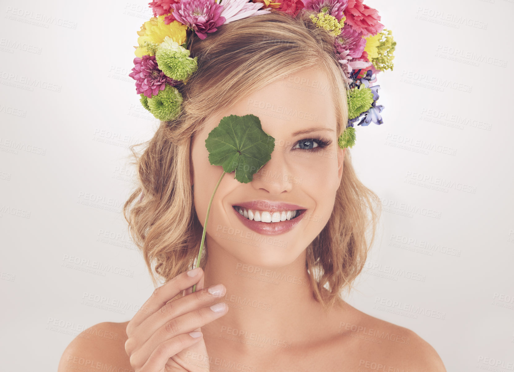 Buy stock photo Woman, portrait and happy with flowers on crown in studio with makeup and leaf for cosmetics and skincare. Spring aesthetic, model and face or smile with floral headband or beauty on white background