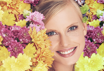 Buy stock photo A young woman with a flower arrangement in her hair smiling at the camera