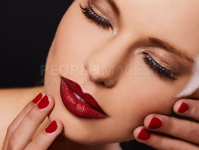 Buy stock photo Beauty, cosmetics and face of woman with manicure, relax and lipstick for creative studio aesthetic. Luxury makeup, skincare and hands with red nail polish for self care, shine and black background