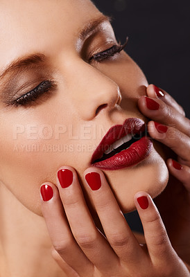 Buy stock photo Face, makeup and manicure with woman isolated on dark background for cosmetics or satisfaction. Salon, red lipstick and nail polish with confident young model in studio for beauty or wellness