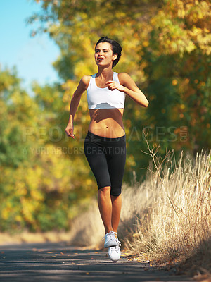 Buy stock photo Woman is running on road, cardio and fitness outdoor in nature with healthy and active person. Sport, exercise and body training for marathon, young female runner workout for health with energy
