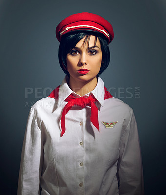 Buy stock photo Studio portrait of a woman dressed in a retro flight attendant uniform