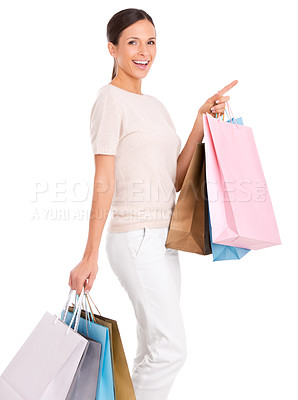 Buy stock photo Pointing, shopping and portrait of woman on a white background with bag for sale, discount and deal news. Fashion, happy customer and isolated person for retail, consumerism and purchase in studio