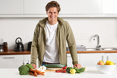 Buy stock photo Portrait of a young man preparing dinner