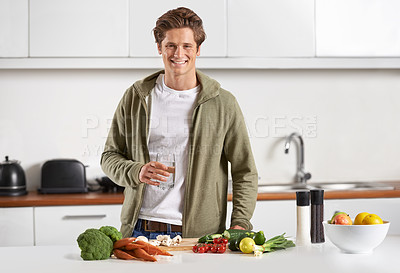 Buy stock photo Portrait of a young man preparing dinner