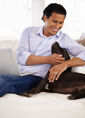 Buy stock photo Man, dog and face with laptop on couch for bonding, playing or happiness with remote work in home. Animal, person and cuddle with smile on sofa in living room for research, comfort and love for puppy