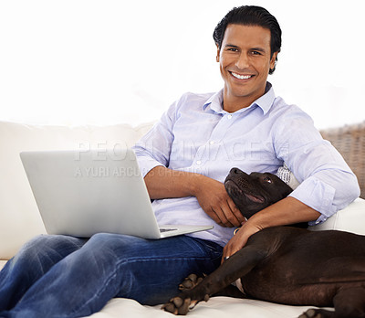 Buy stock photo Man, dog and portrait with laptop on sofa for bonding, playing or happiness with remote work in home. Animal, person and face with smile on couch in living room for research, cuddle or love for puppy