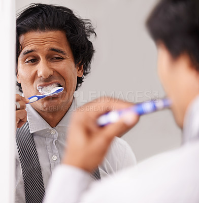 Buy stock photo Businessman, face and brushing teeth in mirror for morning routine, hygiene or cleanliness at home. Closeup of young man or employee in tooth whitening or cleaning mouth, gum or oral for dental care