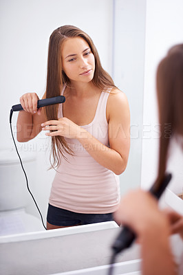 Buy stock photo Girl, smile and bathroom to iron hair with straighter in house, care and style with tool. Happiness, woman and female person with electric flat with heat for adult with reflection on mirror in home
