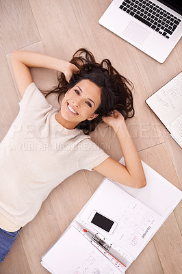Buy stock photo High angle shot of an attractive young woman lying on her floor