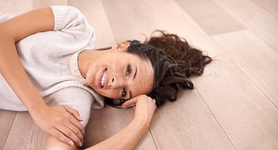 Buy stock photo Woman, portrait and smile on floor for relax with pride, weekend break or confidence in apartment. Person, lying down and face with happiness in home on wooden flooring for fun, freedom or leisure