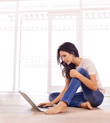 Buy stock photo Laptop, relax and serious with woman on floor of living room in home for email, internet or research. Computer, study and social media with confident young person in apartment for website browsing