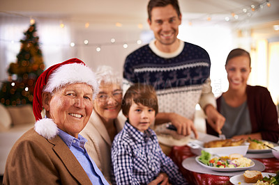 Buy stock photo Family, portrait and grandparents at dinner on Christmas, together with food and celebration in home. Happy, event and kid smile with grandmother at lunch and relax at holiday, party or hosting meal
