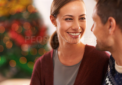 Buy stock photo Smile, conversation and couple on a date on Christmas for romantic, holidays and love bonding. Happy, care and young man and woman talking in living room with xmas festive decoration at home.