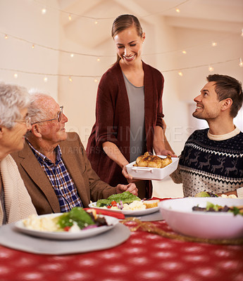 Buy stock photo Christmas, dinner and family smile at table together with food and celebration in home. Senior, mother and father with happiness at lunch with woman hosting holiday with dish of chicken on plate