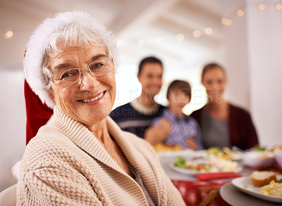 Buy stock photo A happy family sitting around the dinner table on Christmas day