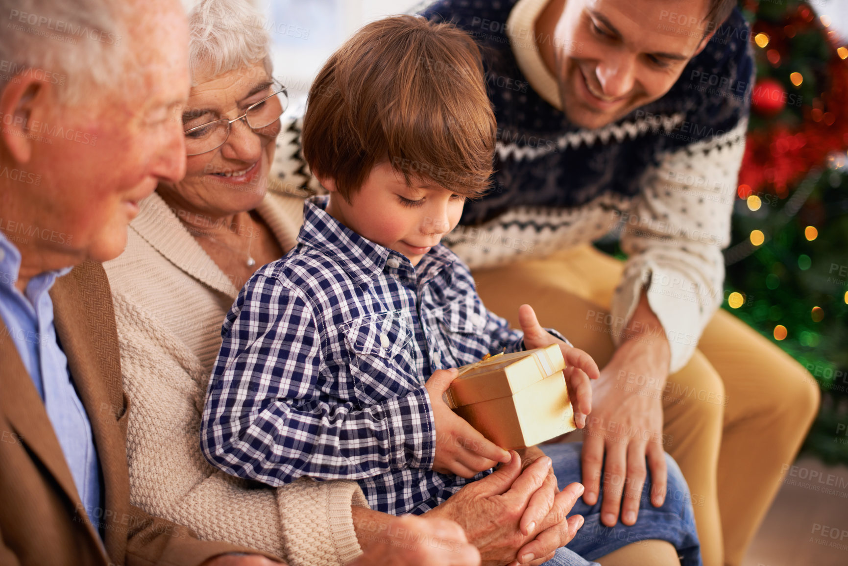 Buy stock photo Father, grandparents and child with Christmas gift for festive season celebration for vacation, package or together. Kid, box and happy family in Canada for traditional holiday, bonding or opening