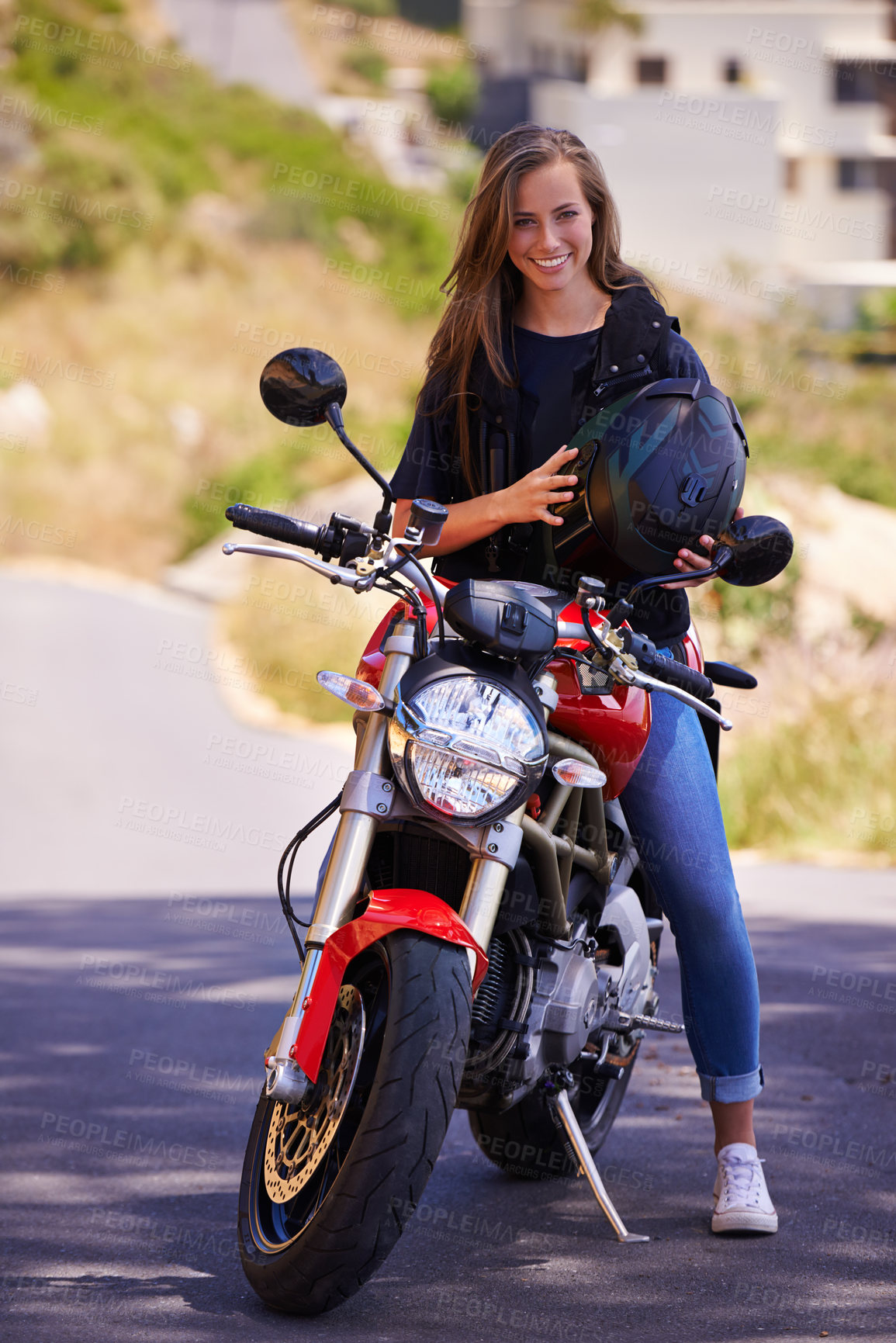 Buy stock photo An attractive young woman sitting on her motorcycle holding her helmet