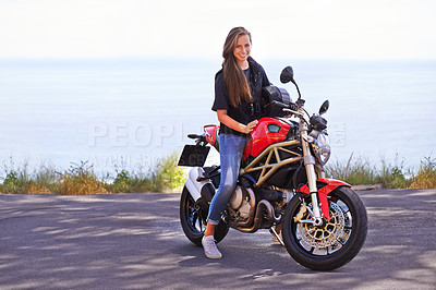 Buy stock photo Happy woman, portrait and rider on motorcycle by the ocean coast for road trip, travel or outdoor holiday in nature. Extreme female person with smile on ride for transport or sightseeing by the beach