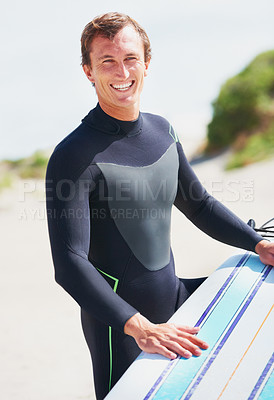 Buy stock photo A surfer resting his board on his leg getting ready for a surf session