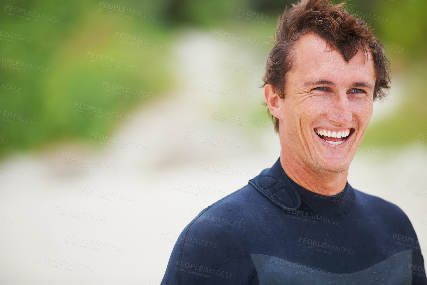 Buy stock photo Shot of a handsome young surfer