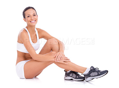 Buy stock photo Studio portrait of an attractive woman in exercise clothing sitting on the floor isolated on white