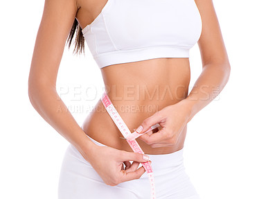Buy stock photo Cropped studio shot of a fit young woman taking her measurements isolated on white